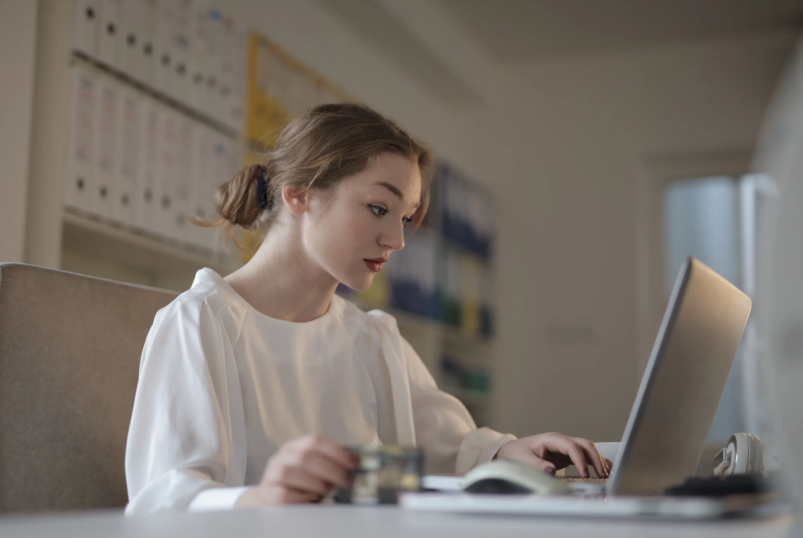Accountant working through her jobs on a laptop at her desk