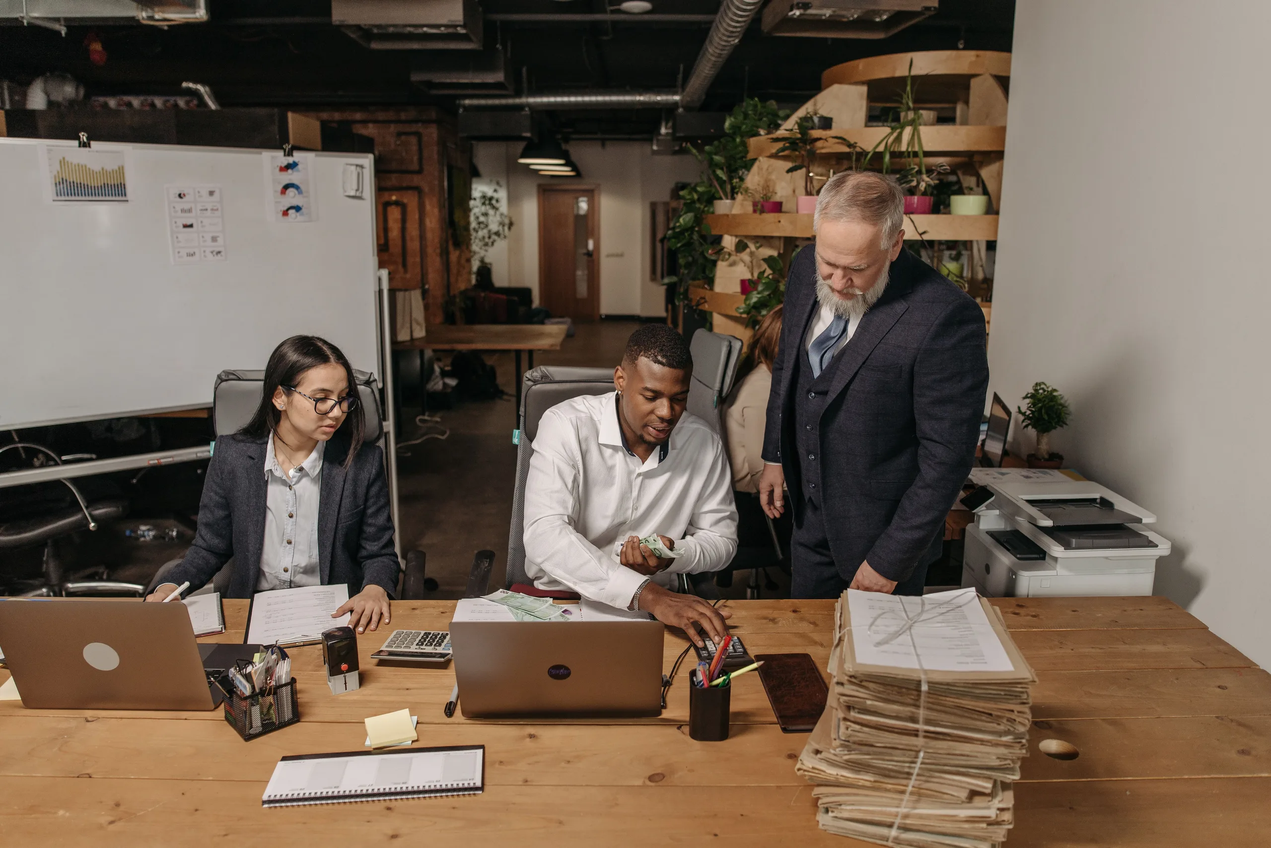 Accounting team working through client files together in their office
