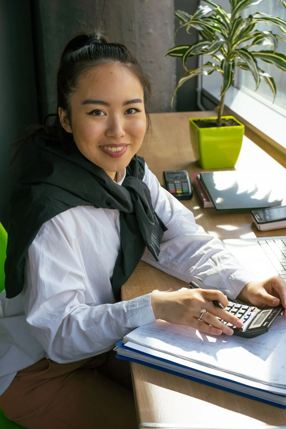An accountant working at a laptop in a bright office with natural light