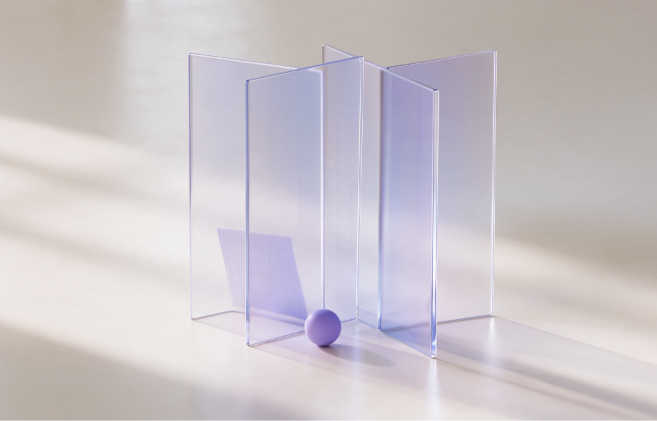 Translucent lavender glass panes standing on a warm studio floor with a small ledger sheet and a purple sphere